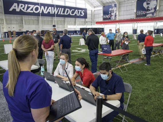A new use for a practice field, testing is conducted in this climate controlled temporary clinic set up inside the Cole and Jeannie Davis Sports Center on the University of Arizona main campus.