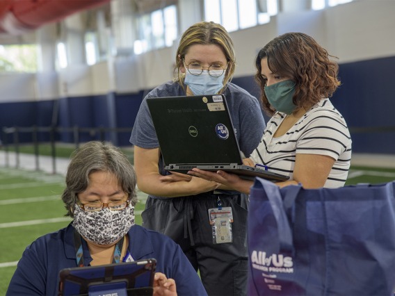 Banner Healthcare workers gather to review charts. The University of Arizona plans to provide antibody blood testing for most of its 45,000 students and 15,000 employees with separate funding. 