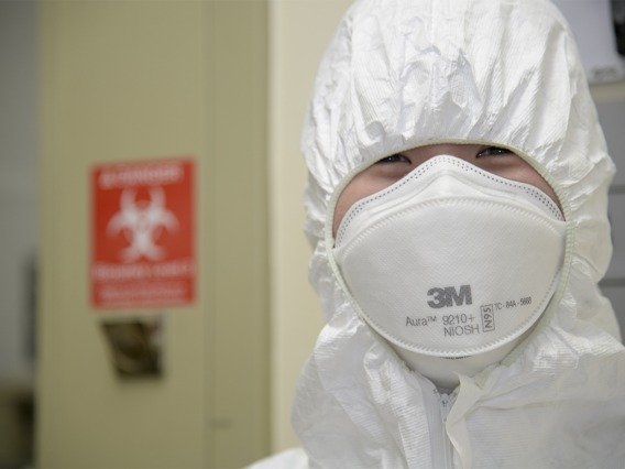 Rachel Wong, a graduate trainee in the Bhattacharya lab, is wearing head-to-toe PPE as she prepares to enter the Biosafety level 3 lab in April to work with samples of the live virus that causes COVID-19.