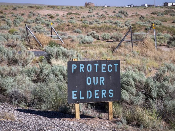 A sign on the Navajo Nation in Loupe, Ariz. reads “Protect our elders.”