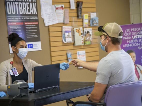 Alexandra Chaput checks Jacob Smith in for his appointment to receive the COVID-19 antibody test in early May at the Pima County Health Department on First Avenue in Tucson.