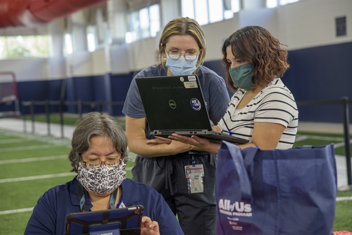 Banner Healthcare workers gather to review charts. The University of Arizona plans to provide antibody blood testing for most of its 45,000 students and 15,000 employees with separate funding. 