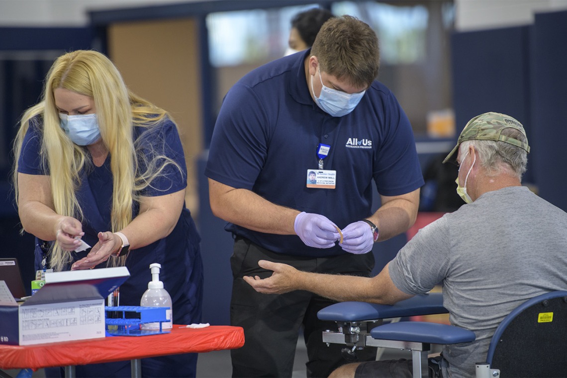 Health care workers assist with blood sample collection. More than 4,500 people are scheduled to have their blood drawn in the first few days of testing.