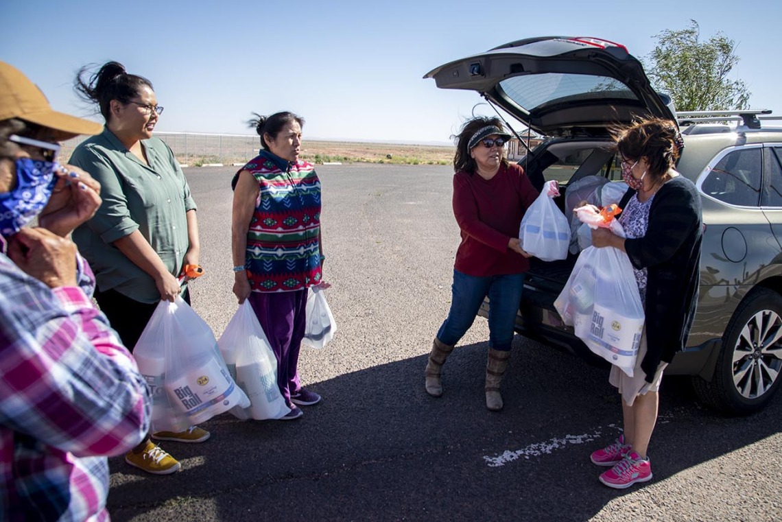 Cora Phillips hands out supplies collected from the University of Arizona Cancer Center drive to people who live in rural areas on the Navajo Nation. Phillips is a member of the Navajo Nation and serves on the Cancer Center’s Community Advisory Committee for the Partnership for Native American Cancer Prevention (NACP), an NCI-funded project at the Cancer Center. The committee consists of leaders who are working in American Indian communities.