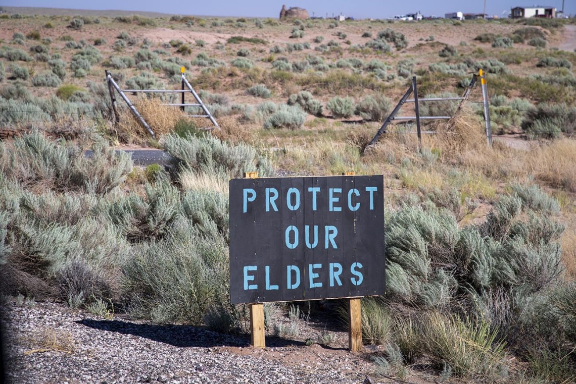 A sign on the Navajo Nation in Loupe, Ariz. reads “Protect our elders.”