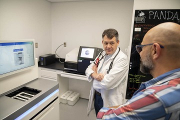 Dr. Michael Daines and Pawel Kiela, DVM, PhD, discuss the new whole genome sequencer at the Steele Children’s Research Center that will allow them to zero in quickly on potential biomarkers for allergy and respiratory disorders.