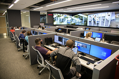 From an adjacent control room, SimDeck participants are observed on monitors