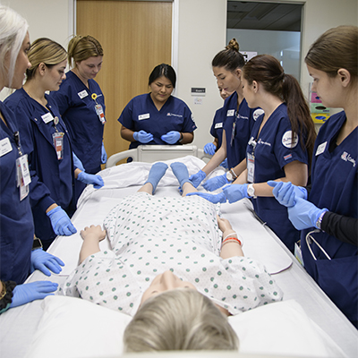 UArizona College of Nursing students in Gilbert practice on a simulated patient manikin.