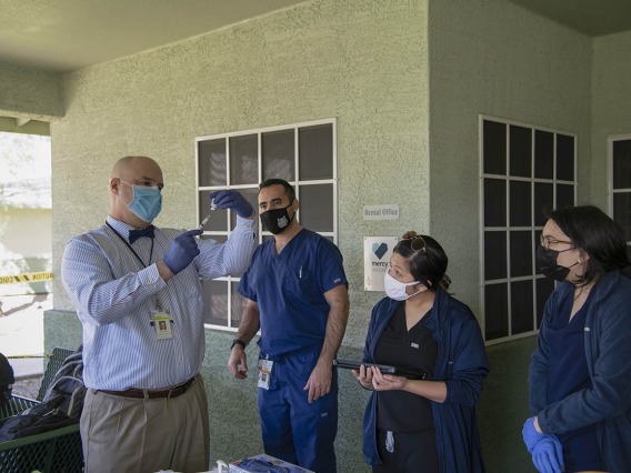 Dr. Jim Lindgren, director of simulation curriculum and clinical assistant professor at College of Medicine in Phoenix, trains medical and pharmacy students to administer the COVID-19 vaccine.