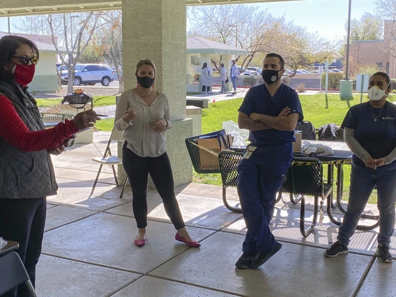 As the COVID-19 vaccine distribution pilot at El Mirage Senior Village wraps up for the day, Dr. Cecilia Rosales of the College of Public Health leads a discussion with her team to learn what worked and what could be improved upon.