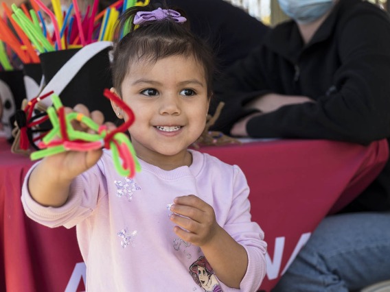 Ariyani Perez shows off a spider she made during the recent Family SciFest at Children's Museum Tucson.