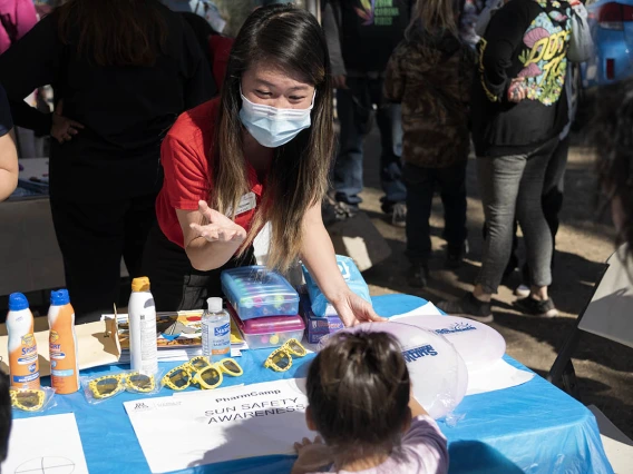 University of Arizona R. Ken Coit College of Pharmacy student Trinh Nguyen teaches children about sun safety during the recent Family SciFest at Children's Museum Tucson.