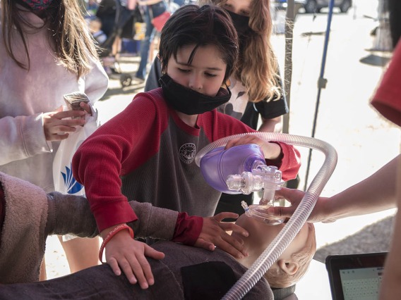 Evander McCauley uses a bag-valve-mask on a Hal, a child-size manikin, at a hands-on display by the Arizona Simulation Technology & Education Center (ASTEC) during the recent Family SciFest at Children's Museum Tucson.