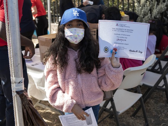 Vanessa Rendon holds up a certificate after completing an activity during the recent Family SciFest at Children's Museum Tucson.