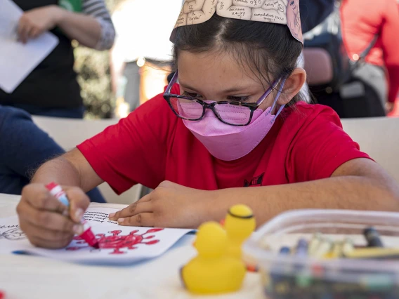 Emma Mendoza colors in a picture of a virus at the R. Ken Coit College of Pharmacy booth during the recent Family SciFest at Children's Museum Tucson. 