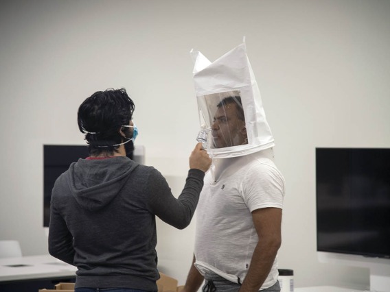 First-year College of Medicine – Tucson student Ahmed Al-Shamari sprays bitters into second-year medical student Waheed Asif’s hooded mask so he can identify their taste during subsequent tests in full protective equipment.