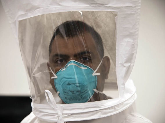 Second-year College of Medicine – Tucson student Waheed Asif wears an N95 mask under the hood, breathing normally to check for the taste of bitters. Then he will take deep breaths.