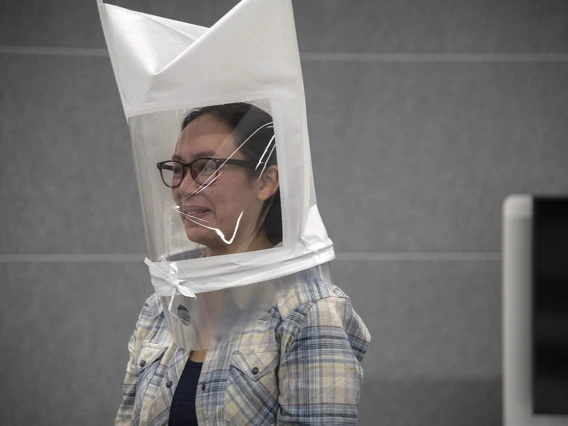 Bitters are sprayed directly into second-year College of Medicine – Tucson student Emerald Montgomery’s hooded mask. Her reaction shows that she is able to taste the bitters. Testers will know her equipment is properly fitted once she is no longer able to taste them.