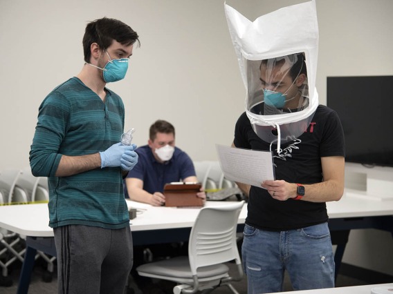 First-year College of Medicine – Tucson student Billy Evans observes second-year student Alexandre Cavalcante reading a passage as part of the fitting exercises.