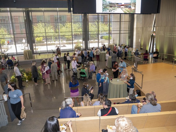 Attendees gather inside the University of Arizona Health Sciences Innovation Building for a reception after the groundbreaking for the Andrew Weil Center for Integrative Medicine.