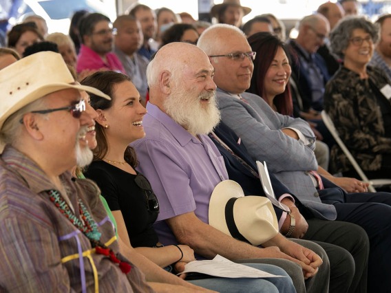 Andrew Weil, MD, (center in purple) laughs along with other attendees of the groundbreaking ceremony for the Andrew Weil Center for Integrative Medicine as University of Arizona President, Robert C. Robbins, MD, relays an anecdote from their first meeting many years ago. 