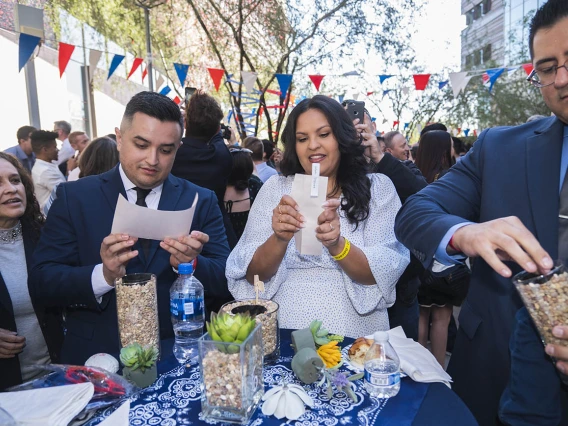 (From left) Jesus Sandoval, Valeria Vasquez and Jesus Leyva open their Match Day letters during the UArizona College of Medicine – Phoenix Match Day 2022 event.