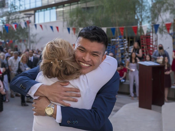 Allen Doan hugs Kelly Lynch, alumni/student relations manager, after being matched during the UArizona College of Medicine – Phoenix Match Day 2022 event.