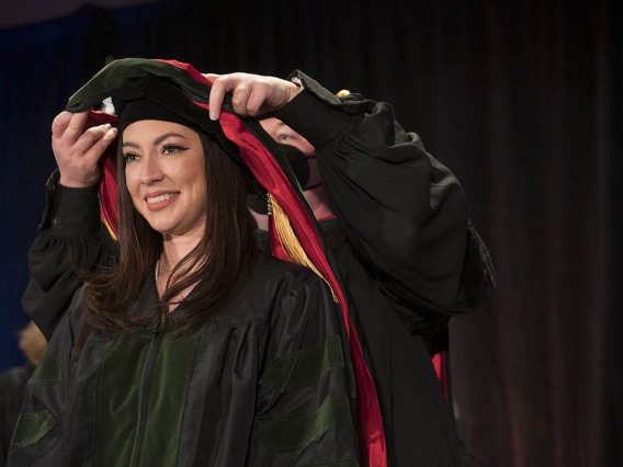Danielle Arias, MD, is hooded during the College of Medicine – Phoenix class of 2022 commencement ceremony at the Phoenix Convention Center.