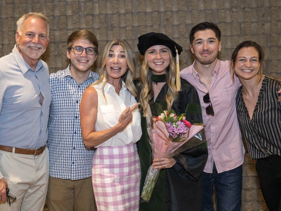 UArizona College of Medicine – Phoenix graduate Claire Grayson, MD, poses for a photo with her family and friends after her class of 2022 commencement ceremony.