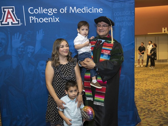 UArizona College of Medicine – Phoenix graduate Jesús Leyva, MD, poses for a photo with his wife, Fabiola, and sons Ivan and Gael after his class of 2022 commencement ceremony. 
