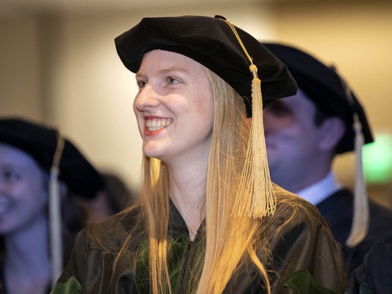 Julia Ghering, MD, is all smiles as she listens to speakers during the College of Medicine – Phoenix class of 2022 commencement ceremony.