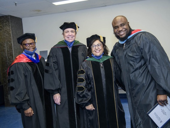 (From left) John Ehiri, PhD, MPH, MSc, associate dean for academic affairs, Michael D. Dake, MD, senior vice president of the University of Arizona Health Sciences, Dean Iman Hakim, MBBCh, PhD, MPH; and Andre Dickerson, MA, MBA, assistant dean of student services and alumni affairs, get ready to congratulate students at the Zuckerman College of Public Health convocation.  