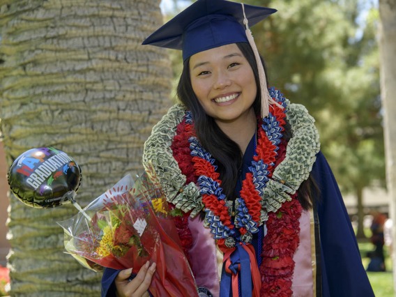 Madison Kim received her bachelor’s degree and plenty of congratulatory gifts from family and friends after the 2022 Mel and Enid Zuckerman College of Public Health spring convocation.
