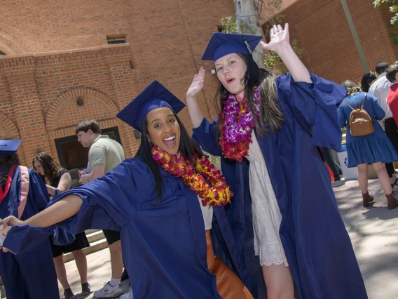 Naomi Abraha, MPH, and Loren Halili, MPH, celebrate after receiving their master’s degrees during the 2022 Mel and Enid Zuckerman College of Public Health spring convocation.