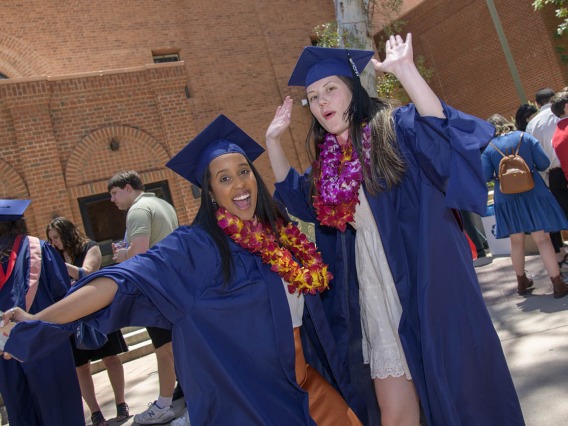 Naomi Abraha, MPH, and Loren Halili, MPH, celebrate after receiving their master’s degrees during the 2022 Mel and Enid Zuckerman College of Public Health spring convocation.