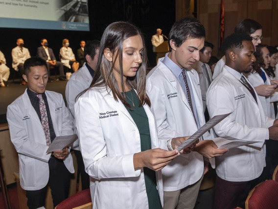 Members of the UArizona College of Medicine – Phoenix Class of 2026 recite the class oath, which they wrote together, near the end of the white coat ceremony. The class will recite the same oath at their graduation.