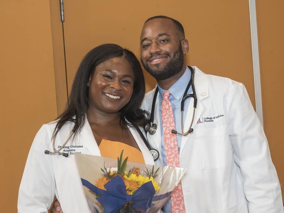 Class of 2026 students Blessing Ozioma Atanmo and Patrick Quarles pose after the UArizona College of Medicine – Phoenix Class of 2026 white coat ceremony.