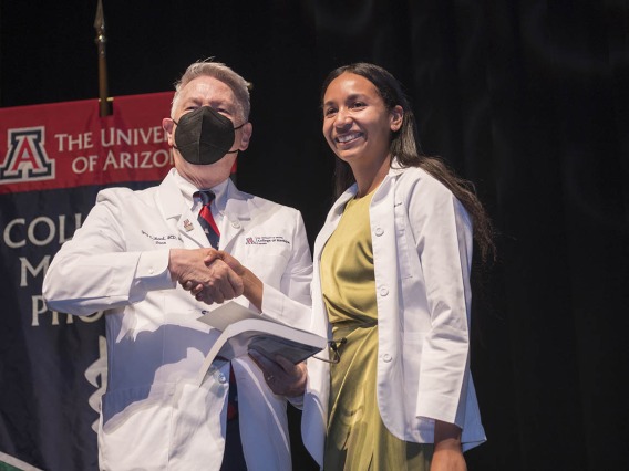UArizona College of Medicine – Phoenix Dean Guy L. Reed, MD, MS, congratulates Santana Solomon after she received her white coat at the college’s Class of 2026 white coat ceremony.