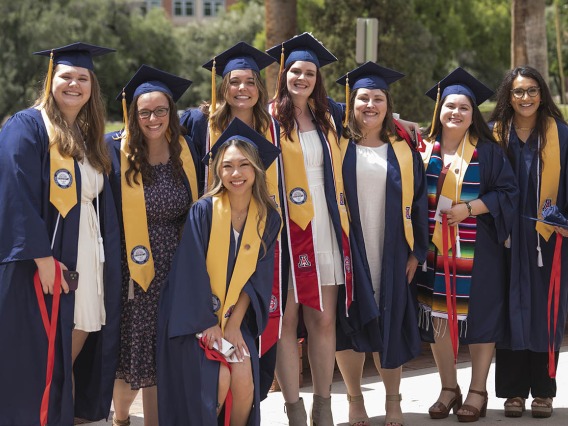 College of Nursing 2022 summer graduates from the Bachelor of Science in Nursing Integrative Health Pathway program gather for a photo outside of Centennial Hall.