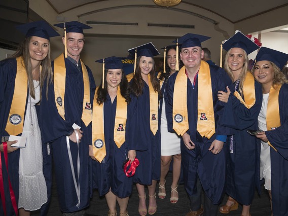 Bachelor of Science in Nursing Integrative Health Pathway graduates pause for a photo in the lobby of Centennial Hall during the College of Nursing’s 2022 summer convocation.