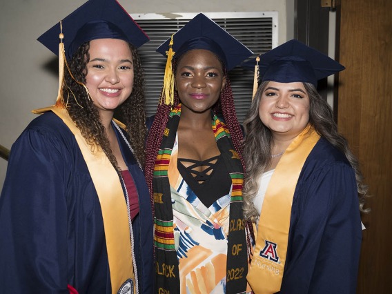 (From left) Deja Taggart, Minette Anu and Yatzel Alvarez pause backstage at Centennial Hall during the College of Nursing’s 2022 summer convocation before receiving their bachelor’s degrees in nursing integrative health pathway.