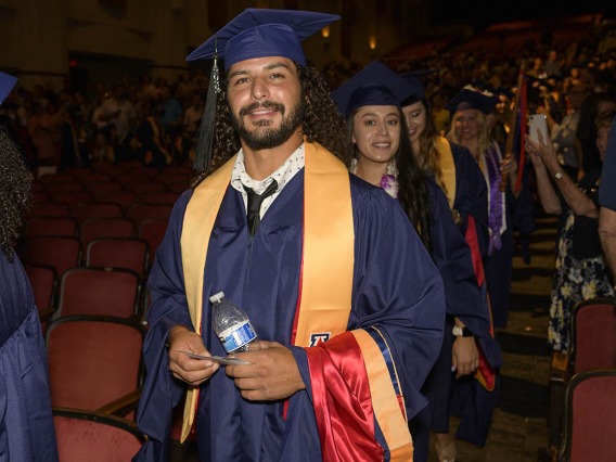 Master of Science in Nursing Entry to the Profession student Daniel Thews enters Centennial Hall with his classmates at the start of the UArizona College of Nursing summer convocation ceremony.