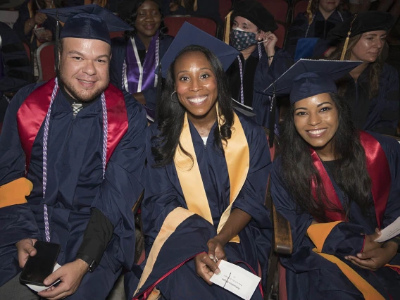 Felipe Jimenez, Rahsadara Wright and Leila Darbouze, all Master of Science in Nursing Entry to the Profession students, wait for the College of Nursing 2022 summer convocation to begin.