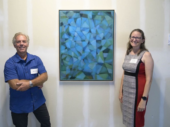 Artist Mark Pomilio and Taben Hale, PhD, an associate professor in the College of Medicine – Phoenix, stands next to the painting “Tissue Study I” during the VIP opening of the Artist + Researcher project. 