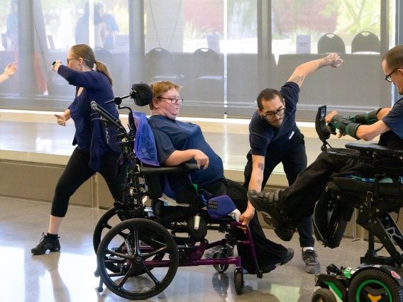 A group of dancers, two in wheelchairs, perform an interpritive dance. 