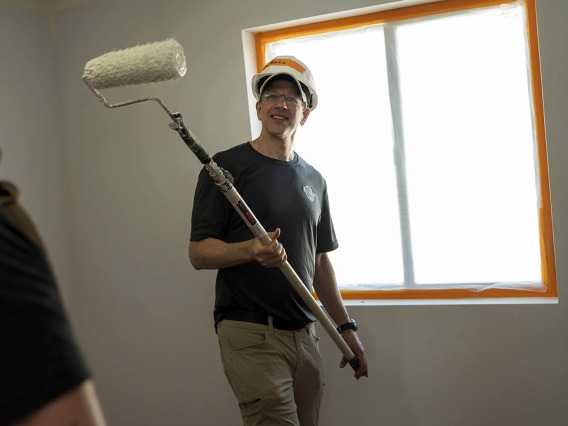 Daniel Beskind, MD, MPH, FACEP, an associate professor in the College of Medicine – Tucson’s Department of Emergency Medicine, takes a break from painting the ceiling of a Habitat for Humanity house during the EM Day of Service.  