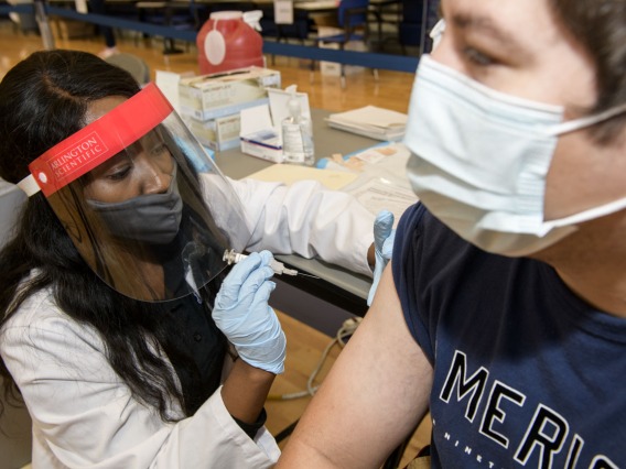 College of Pharmacy student Judy Mburu administers a flu vaccination to a student, hoping to create a comfortable environment to help patients feel at ease. “When you, as the immunizer, get comfortable, the patient will also get comfortable,” Mburu says “They’re not going to feel afraid or worried.”