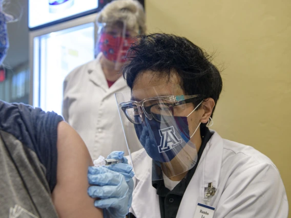 PharmD student Rambo Le administers a flu shot as preceptor Deborah Van Sant, PharmD, observes from behind him. “The flu is a lot worse than getting the flu shot,” he says, encouraging everyone to get immunized this season.