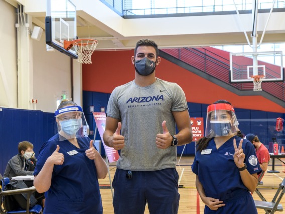 Hailey Finn and Michelle Garcia, members of the College of Nursing Master’s Entry to the Profession of Nursing (MEPN) program, pose for a photo with Chase Jones, a member of the UArizona men’s indoor volleyball club and an undergraduate student in psychology and criminal justice.