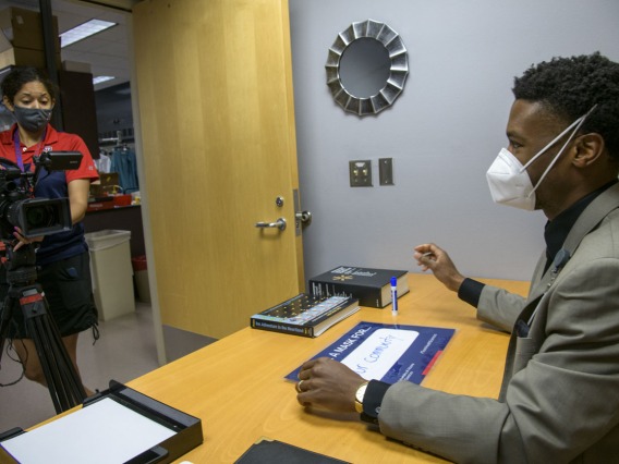 During video production for the “I Wear a Mask” campaign, Viola Watson, videographer for the UArizona Health Sciences Office of Communications, interviews Ike Chinyere,MD/PHD student, at the College of Medicine – Tucson, as he discusses the importance of wearing a mask.